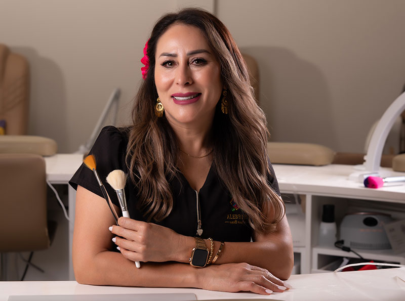 a woman holding makeup brushes