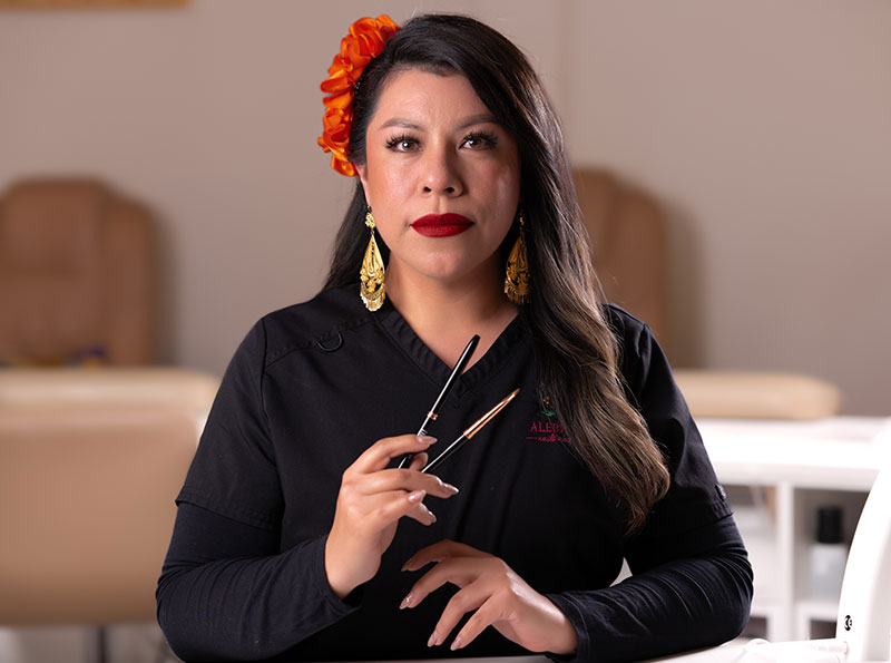 a woman holding a pair of brushes